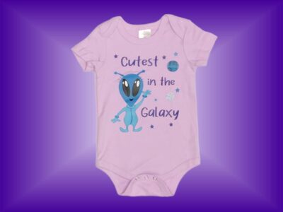 Cutest in the Galaxy Baby Girl Alien Onesie. Cute Baby Girl Alien Design on Light Purple with Alien and Space Saucer Pattern Leggings. Sizes 3 to 18 months.