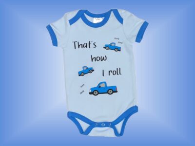 That's How I Roll Onesie. Cute Baby Boy Onesie or T-shirt with Bright Blue Trucks and "That's How I Roll" on Light Blue with Blue Hem. Matching Sweatpants in Blue. Sizes 3 to 18 months.